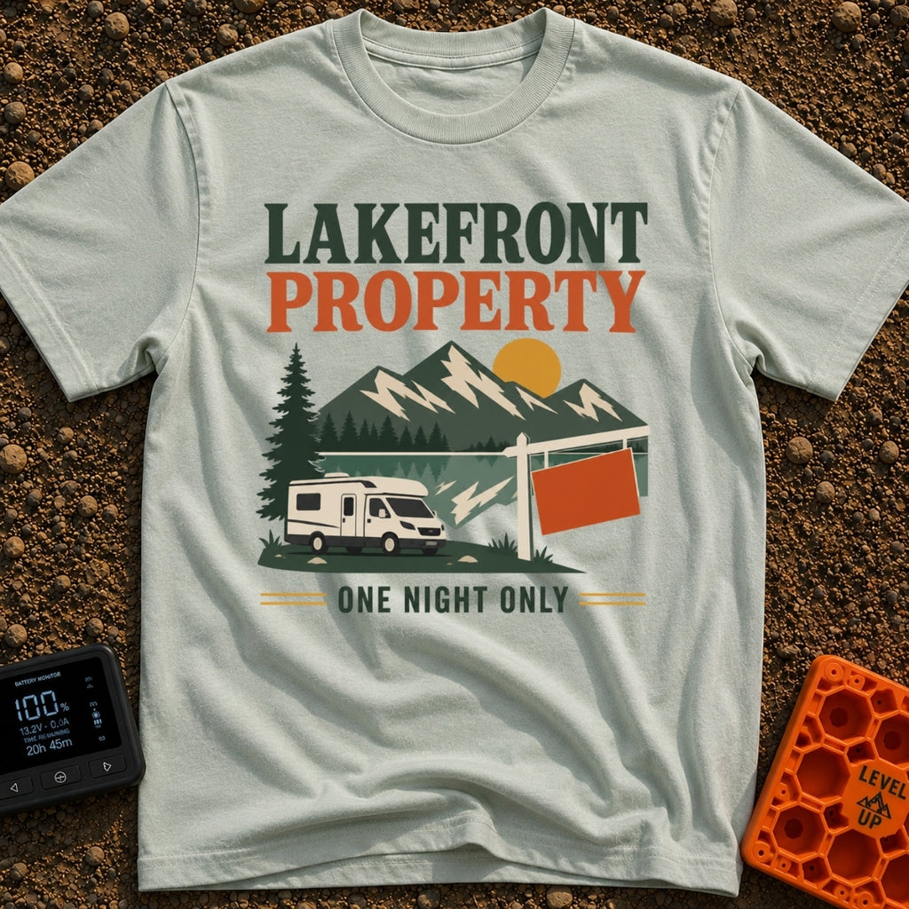 Overnight Lakefront Property - T-Shirt in Bay - A graphic of a Class C motorhome parked next to a lake, pine trees, and a...
