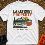 Overnight Lakefront Property - T-Shirt in White - A graphic of a Class C motorhome parked next to a lake, pine trees, and...
