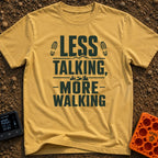 Less Talk More Walk - T-Shirt in Mustard - A typographic design reading "LESS TALKING, -MORE- WALKING" decorated with...