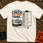 Just One More Check - T-Shirt in Ivory - A graphic featuring a white camper van parked by a campfire and camp chair with...