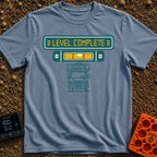 Finally Level Complete - T-Shirt in Blue Jean - A graphical design featuring a teal sign with yellow text reading 'LEVEL...