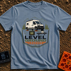 Level Ground Legends - T-Shirt in Blue Jean - A white camper van parked on orange leveling blocks in front of mountains...
