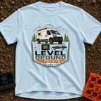 Level Ground Legends - T-Shirt in Chambray - A white camper van parked on orange leveling blocks in front of mountains...