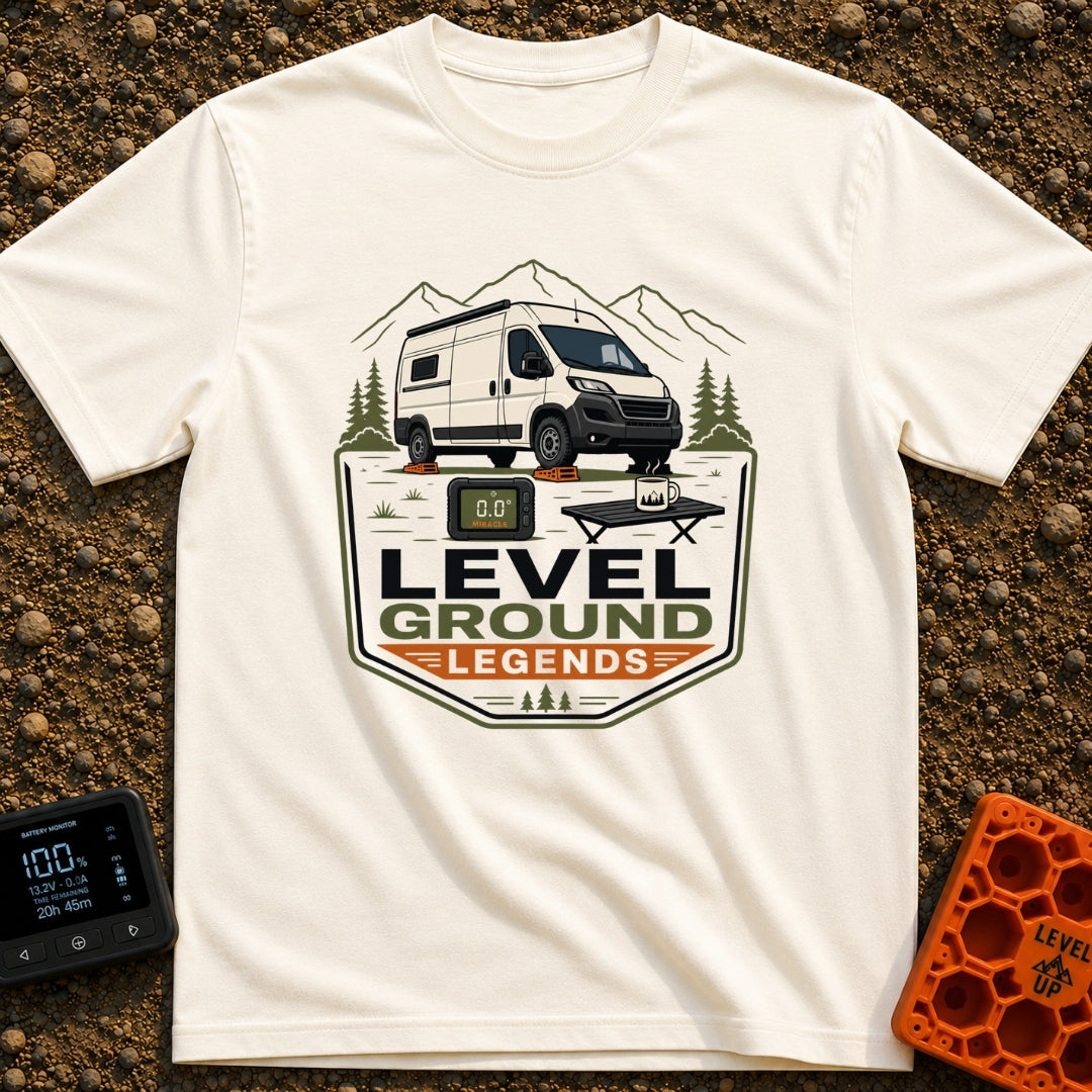 Level Ground Legends - T-Shirt in Ivory - A white camper van parked on orange leveling blocks in front of mountains and...