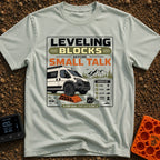 Leveling Before Small Talk - T-Shirt in Bay - A graphic featuring a camper van parked with its front wheel on an orange...
