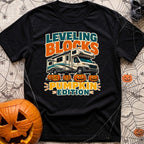 Pumpkin Spice Leveling - T-Shirt in Black - A graphic showing a Class C motorhome parked with its tires resting on top of...