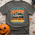 Pumpkin Spice Leveling - T-Shirt in Pepper - A graphic showing a Class C motorhome parked with its tires resting on top...