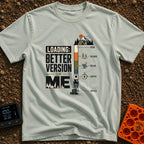 Better Version Loading - T-Shirt in Bay - A graphic reading "LOADING: BETTER VERSION OF ME" next to a vertical progress...