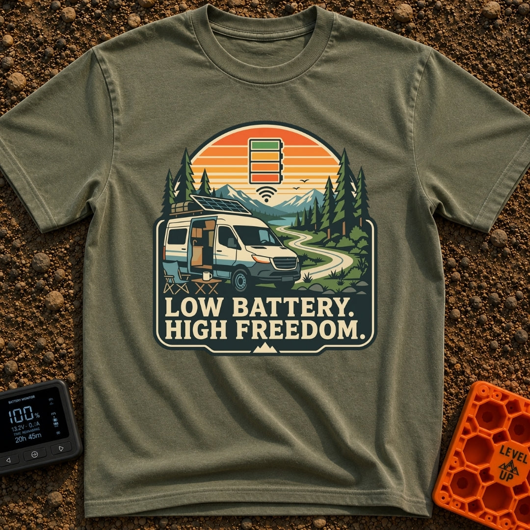 Freedom Over Fuel - T-Shirt in Moss - A camper van with a tilted roof solar panel is parked along a winding dirt road...
