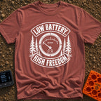 Unplugged And Free - T-Shirt in Brick - A distressed black-and-white illustration of an analog battery gauge with its...