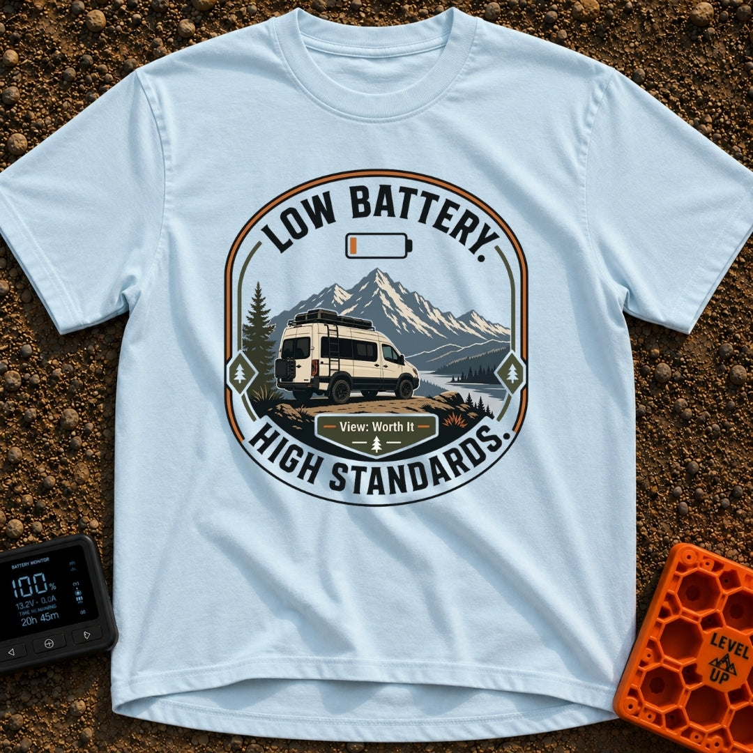 Low Battery High Standards - T-Shirt in Chambray - A badge-style graphic featuring a white camper van parked on a dirt...
