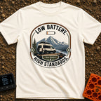 Low Battery High Standards - T-Shirt in Ivory - A badge-style graphic featuring a white camper van parked on a dirt...