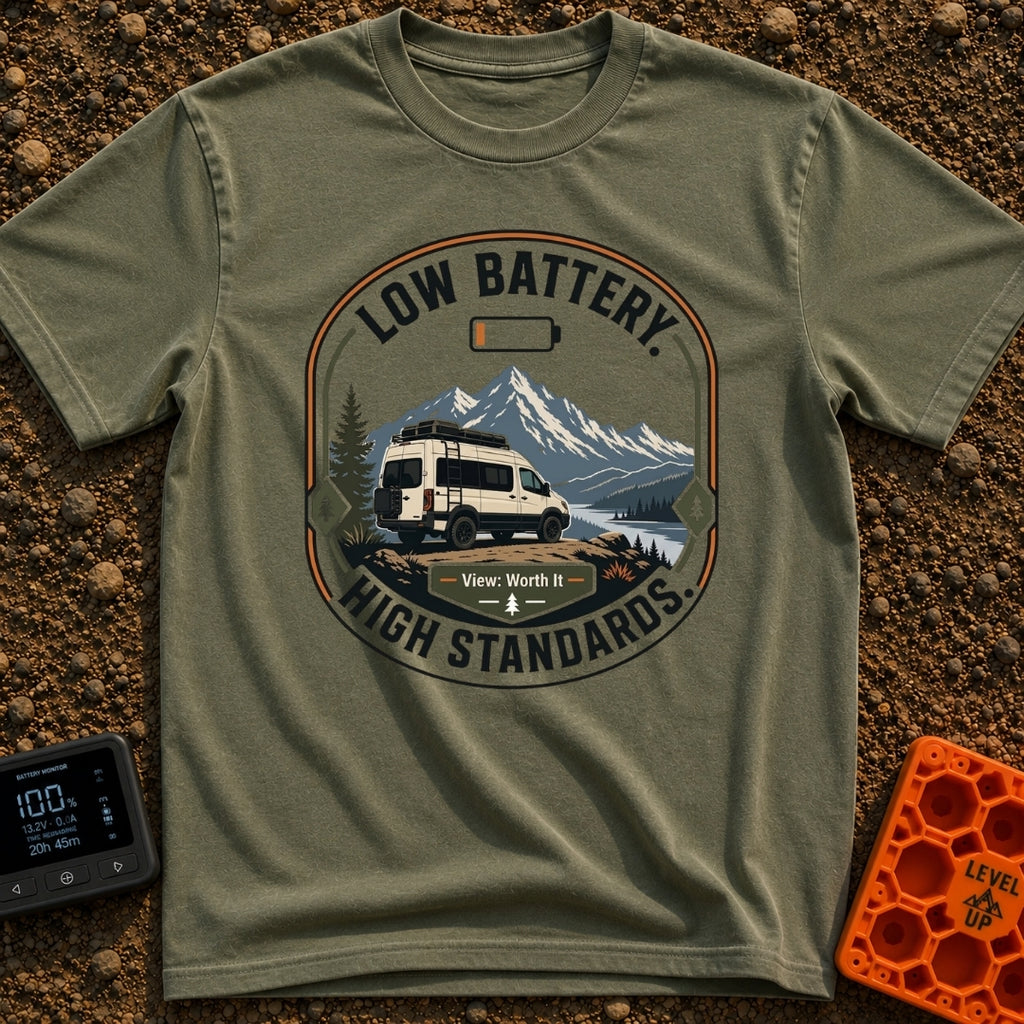Low Battery High Standards - T-Shirt in Moss - A badge-style graphic featuring a white camper van parked on a dirt...