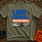 Low Signal Tail Wags - T-Shirt in Moss - The design features bold text reading "LOW SIGNAL HIGH TAIL WAGS" alongside an...