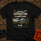 Campfire Marriage Counseling - T-Shirt in Black - A white camper van parked by a mountain lake, with two empty camp...