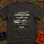 Campfire Marriage Counseling - T-Shirt in Graphite - A white camper van parked by a mountain lake, with two empty camp...