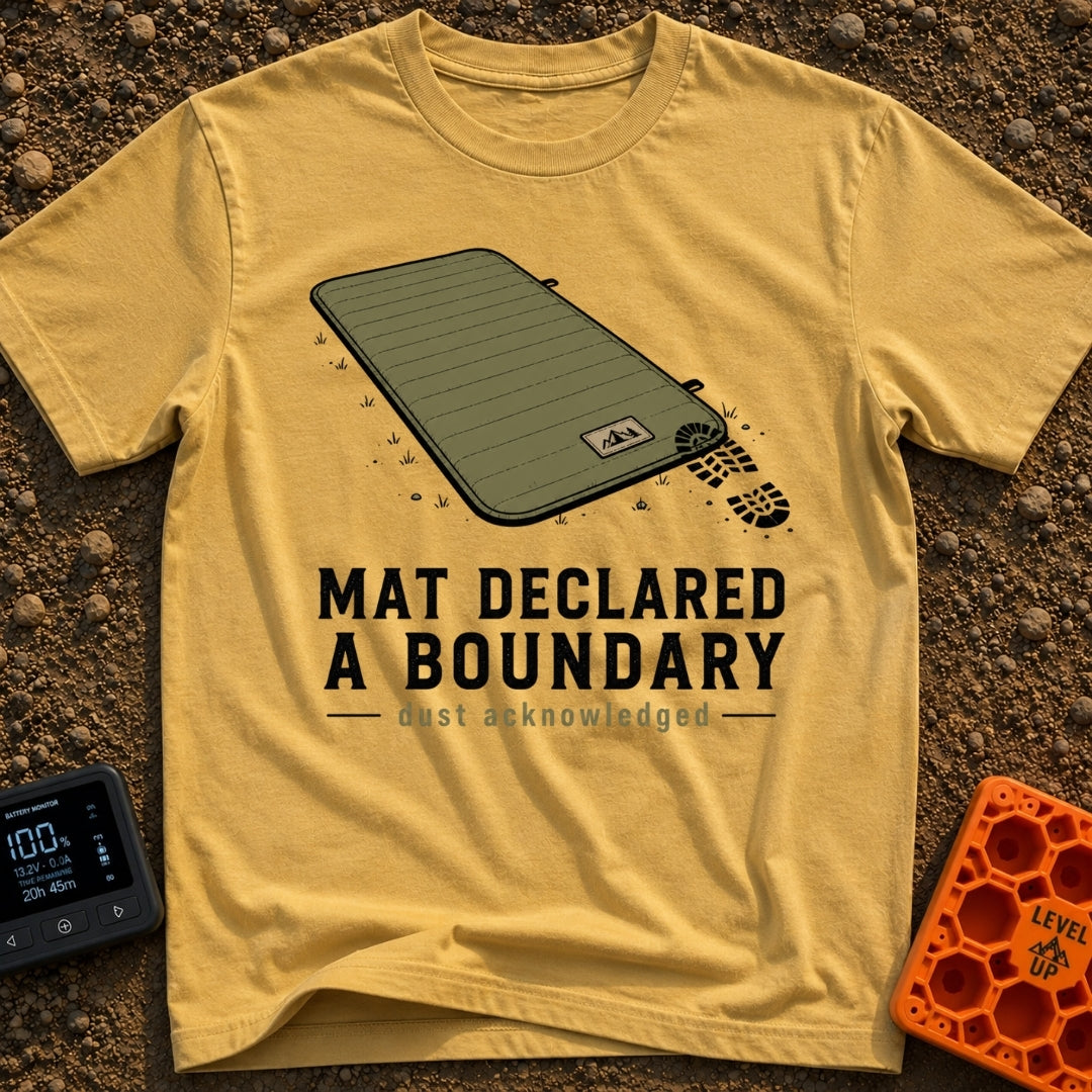 Boundary Mat Mischief - T-Shirt in Mustard - An illustration of an olive green quilted camping mat lying on dirt and...
