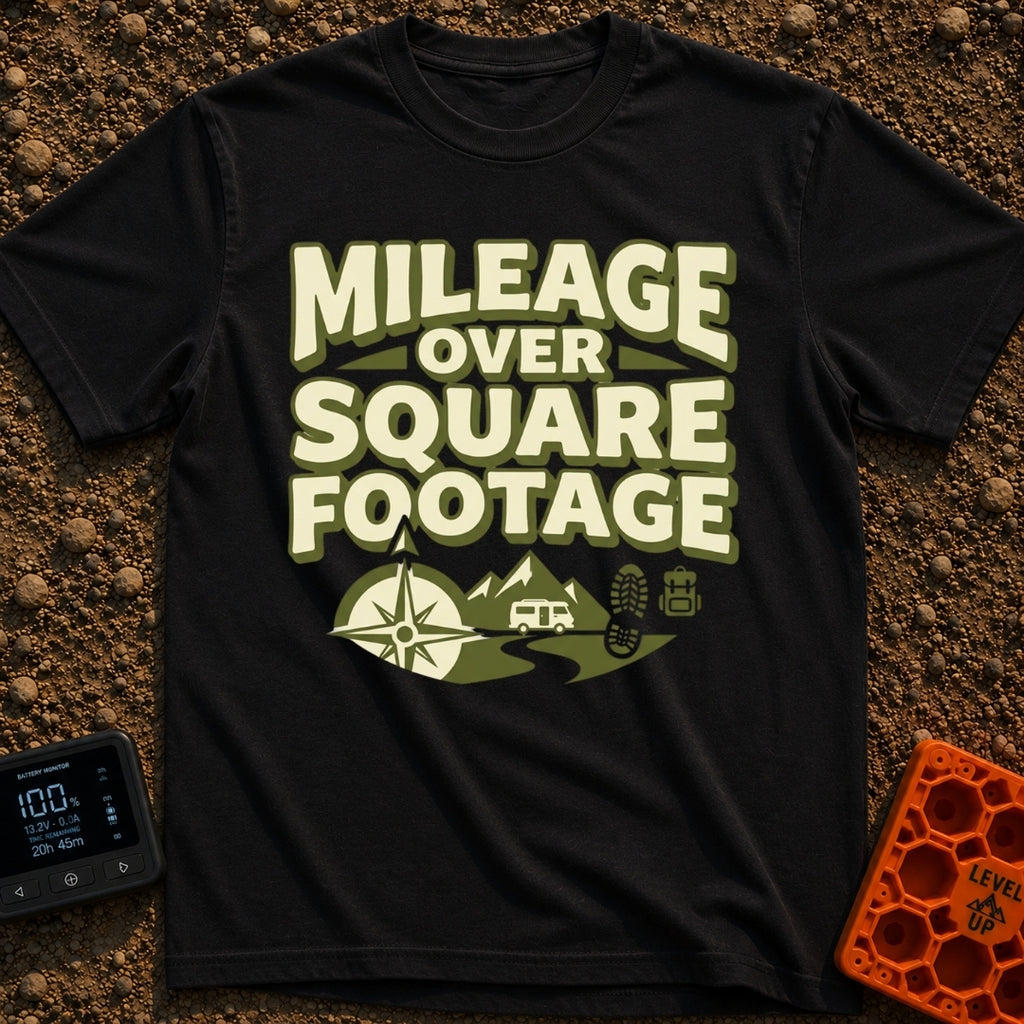 Miles Over Space - T-Shirt in Black - The design features the text "MILEAGE OVER SQUARE FOOTAGE" stacked above a scene...