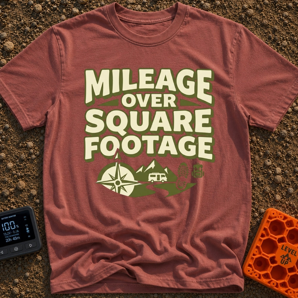 Miles Over Space - T-Shirt in Brick - The design features the text "MILEAGE OVER SQUARE FOOTAGE" stacked above a scene...