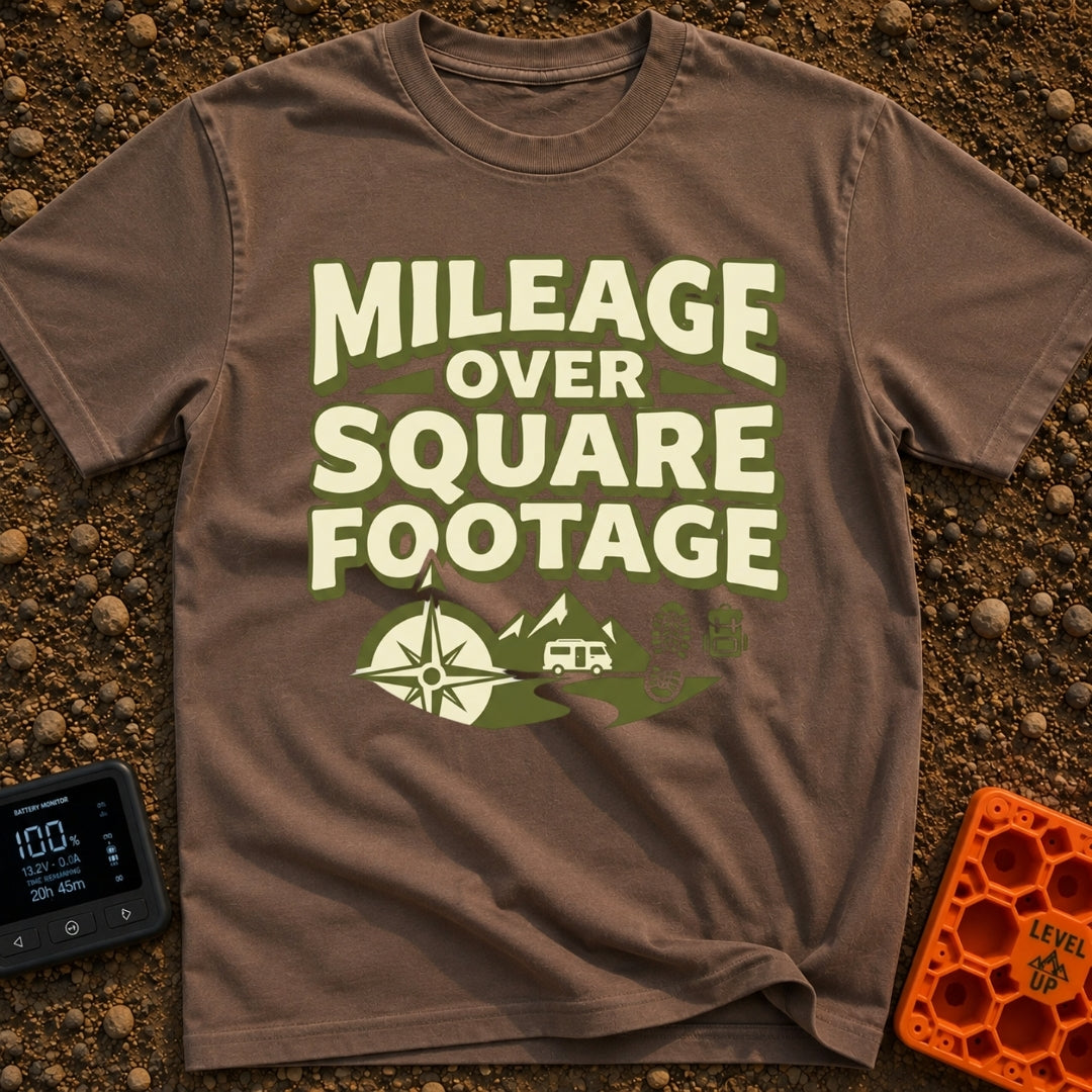 Miles Over Space - T-Shirt in Espresso - The design features the text "MILEAGE OVER SQUARE FOOTAGE" stacked above a scene...