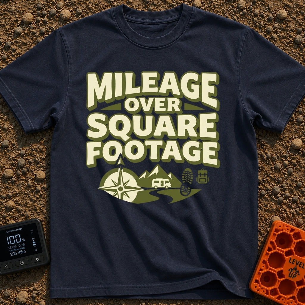 Miles Over Space - T-Shirt in Navy - The design features the text "MILEAGE OVER SQUARE FOOTAGE" stacked above a scene...