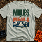 Miles, Meals, Moonlight - T-Shirt in Bay - A typographic design reading "MILES & MEALS MOONLIGHT" featuring hiking boot...
