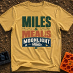Miles, Meals, Moonlight - T-Shirt in Mustard - A typographic design reading "MILES & MEALS MOONLIGHT" featuring hiking...