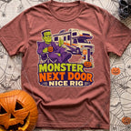 Monster Says Nice Rig - T-Shirt in Brick - A cartoon illustration of Frankenstein's monster sitting in a camp chair...
