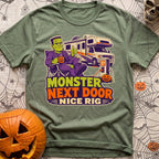 Monster Says Nice Rig - T-Shirt in Moss - A cartoon illustration of Frankenstein's monster sitting in a camp chair giving...