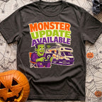 Beast Update Pending - T-Shirt in Graphite - A cartoon illustration of Frankenstein's monster sitting in a camp chair,...