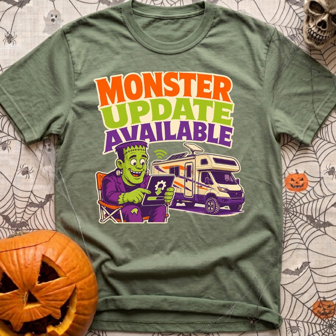 Beast Update Pending - T-Shirt in Moss - A cartoon illustration of Frankenstein's monster sitting in a camp chair,...