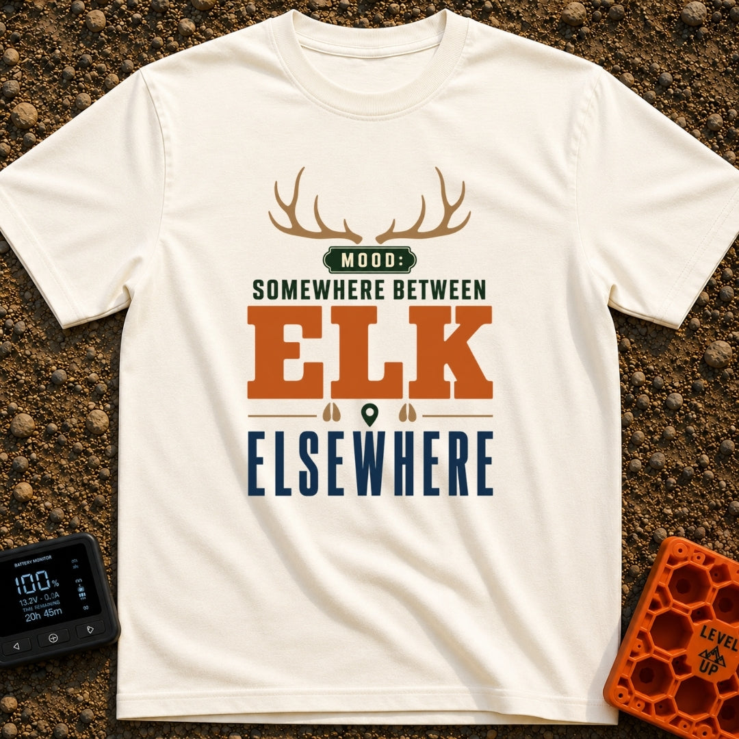 Between Elk And Elsewhere - T-Shirt in Ivory - A typographic design featuring a pair of elk antlers at the top above the...