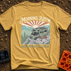 Sunrise Brew View - T-Shirt in Mustard - A camper van with a large roof-mounted solar panel is parked on a rocky cliff...