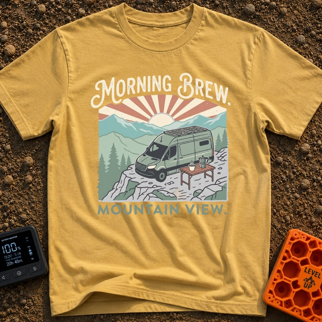 Brews With Views - T-Shirt in Mustard - A green campervan with roof-mounted solar panels is parked on a rocky cliff...