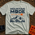 Mountain Mode On - T-Shirt in Bay - The design features bold text reading "MOUNTAIN MODE" above an orange digital toggle...