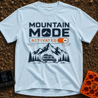 Mountain Mode On - T-Shirt in Chambray - The design features bold text reading "MOUNTAIN MODE" above an orange digital...