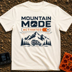 Mountain Mode On - T-Shirt in Ivory - The design features bold text reading "MOUNTAIN MODE" above an orange digital...