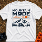 Mountain Mode On - T-Shirt in White - The design features bold text reading "MOUNTAIN MODE" above an orange digital...