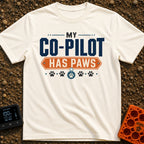 My Copilot Has Paws - T-Shirt in Ivory - A typography-based design featuring the text 'MY CO-PILOT' in large blue letters...