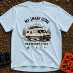 Mud-Covered Smart Home - T-Shirt in Chambray - An illustration of a mud-splattered white camper van equipped with a...