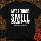 Mysterious Smell Commit - T-Shirt in Black - The design features the text "MYSTERIOUS SMELL COMMITTEE" in large block...
