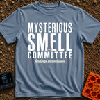 Mysterious Smell Commit - T-Shirt in Blue Jean - The design features the text "MYSTERIOUS SMELL COMMITTEE" in large block...