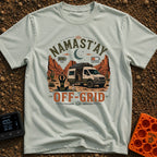 Namastay Off Grid - T-Shirt in Bay - A person is sitting cross-legged on a yoga mat beside a steaming mug of coffee,...