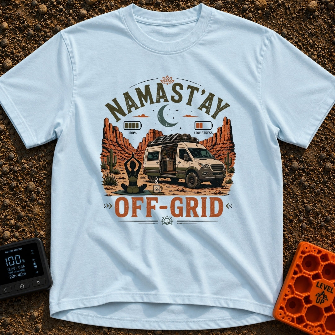 Namastay Off Grid - T-Shirt in Chambray - A person is sitting cross-legged on a yoga mat beside a steaming mug of coffee,...