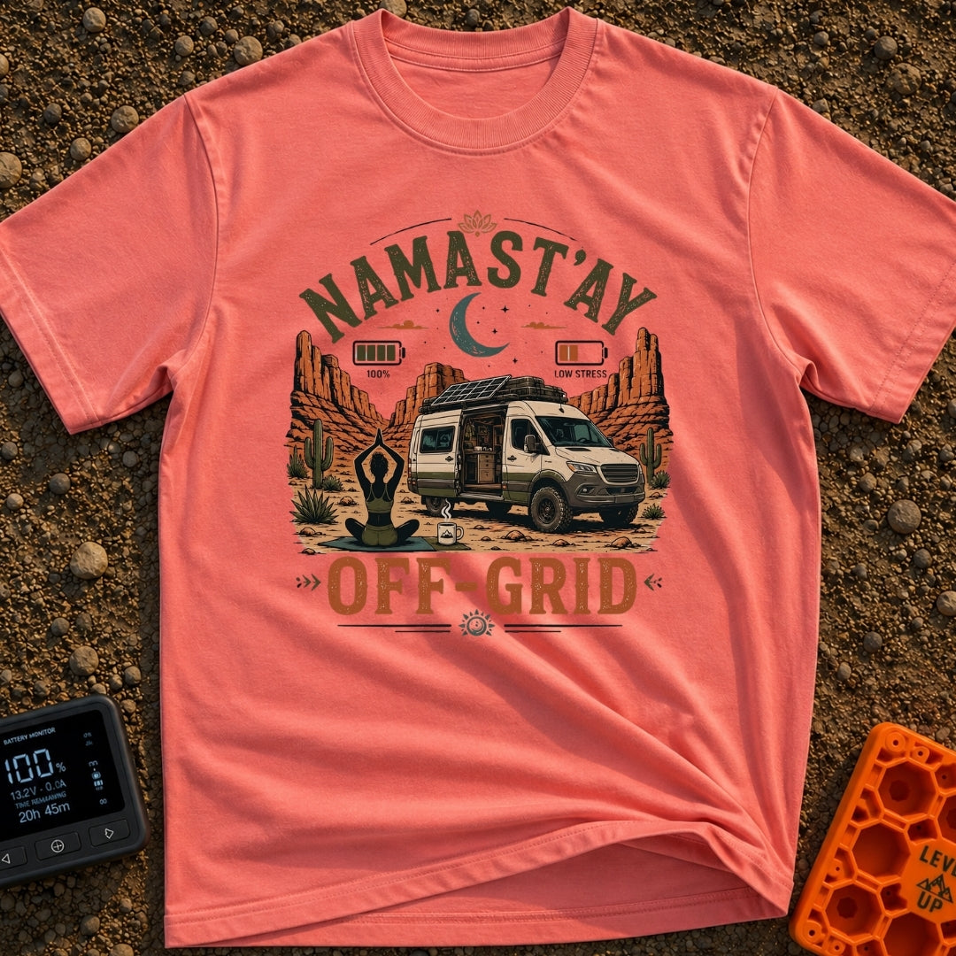 Namastay Off Grid - T-Shirt in Watermelon - A person is sitting cross-legged on a yoga mat beside a steaming mug of...