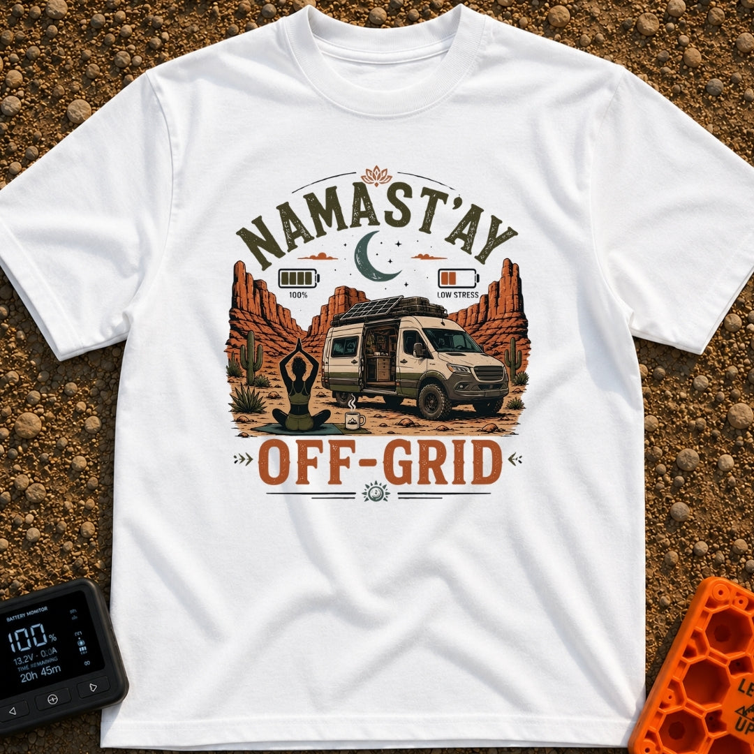 Namastay Off Grid - T-Shirt in White - A person is sitting cross-legged on a yoga mat beside a steaming mug of coffee,...