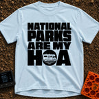 Parks Are My HOA - T-Shirt in Chambray - Bold black text that reads "NATIONAL PARKS ARE MY HOA", where the letter "O" in...