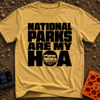 Parks Are My HOA - T-Shirt in Mustard - Bold black text that reads "NATIONAL PARKS ARE MY HOA", where the letter "O" in...