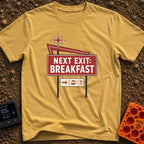 Breakfast Next Exit - T-Shirt in Mustard - A vintage-style roadside sign with a red starburst and arrow, featuring a...