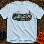 Room With A View - T-Shirt in Chambray - A white RV with an open side, solar panels, and a satellite dish is parked by a...